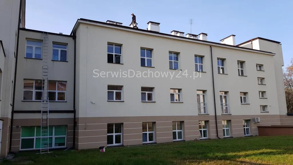 Ekipa Serwisu Dachowego w bramie kamienicy